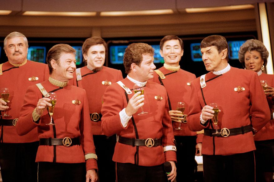 Members of the "Star Trek" crew, from left, James Doohan, DeForest Kelley, Walter Koenig, William Shatner, George Takei, Leonard Nimoy, and Nichelle Nichols, toast the newest "Star Trek" film at Paramount Studios on Dec. 28, 1988. (AP Photo/Bob Galbraith, File)