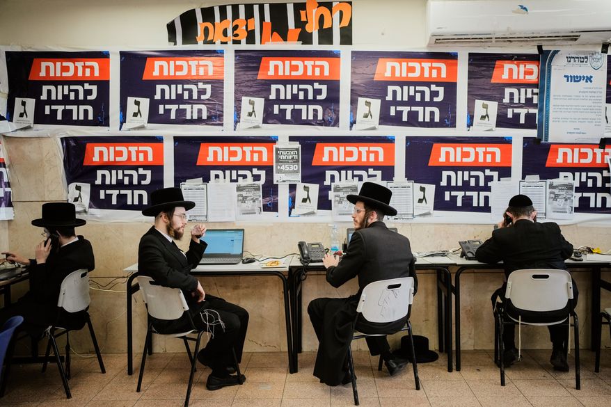 Ultra-Orthodox Jewish men work at the United Torah Judaism (Yahadut HaTorah) party headquarters during Israel's general election in Jerusalem, Tuesday, Oct. 27, 2026. (AP Photo/Ohad Zwigenberg)