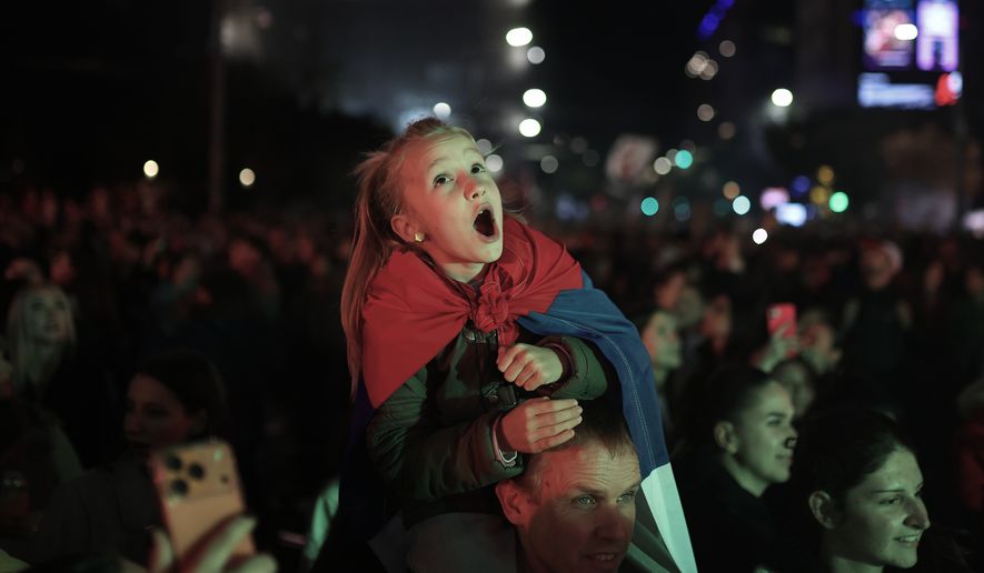 People celebrate the night after the student-led opposition movement won the parliamentary election and defeated Aleksandar Vucic's ruling Serbian Progressive Party (SNS), in Belgrade, Serbia, late Monday, Oct. 26, 2026. (AP Photo/Armin Durgut)