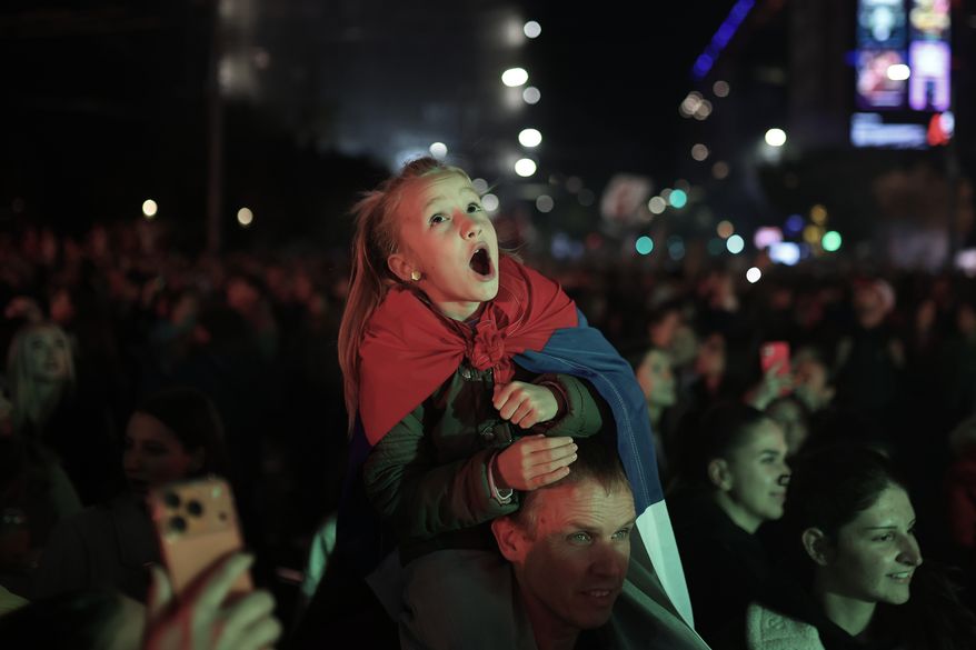 People celebrate the night after the student-led opposition movement won the parliamentary election and defeated Aleksandar Vucic's ruling Serbian Progressive Party (SNS), in Belgrade, Serbia, late Monday, Oct. 26, 2026. (AP Photo/Armin Durgut)