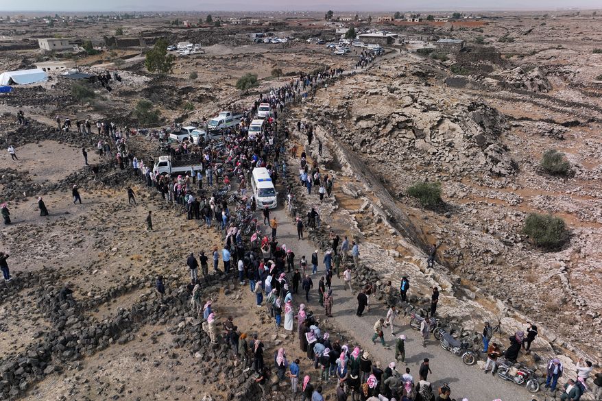 Mourners join the funeral procession for five family members, including three children, killed in a Jordanian airstrike in Al-Tuff in southern Syria's Daraa province, Tuesday, Oct. 27, 2026, following attacks Jordan said targeted Islamic State militants and acknowledged also killed civilians. (AP Photo/Ghaith Alsayed)