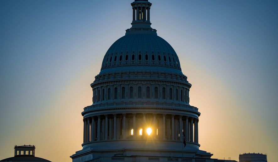 The sun rises behind the Capitol Dome in Washington, Tuesday, Oct. 20, 2026, two weeks before the midterm elections that will determine political control of Congress. (AP Photo/J. Scott Applewhite)
