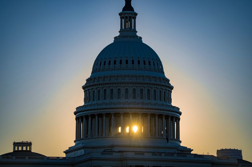 The sun rises behind the Capitol Dome in Washington, Tuesday, Oct. 20, 2026, two weeks before the midterm elections that will determine political control of Congress. (AP Photo/J. Scott Applewhite)
