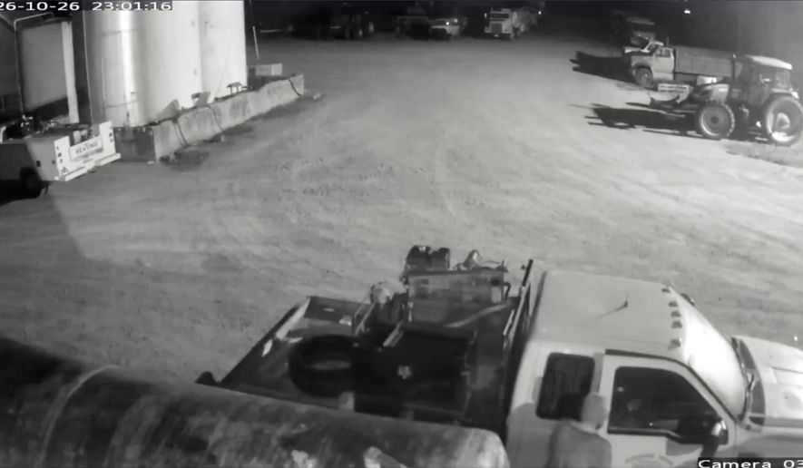 This image from security video provided by John Lindamood shows escaped inmate Jacob Allen Morley, bottom right, stealing a white Ford F-350 from the Lindamood Planting Company early Monday, Oct. 26, 2026, in Lake County, Tenn. (John Lindamood via AP)