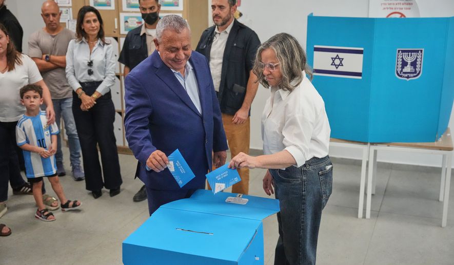 Gadi Eisenkot, leader of the Yashar ("Straight") party, and his wife, Hannah Eisenkot, cast their ballots at a polling station during Israel's general election in Herzliya, Israel, Tuesday, Oct. 27, 2026. (AP Photo/Ariel Schalit)