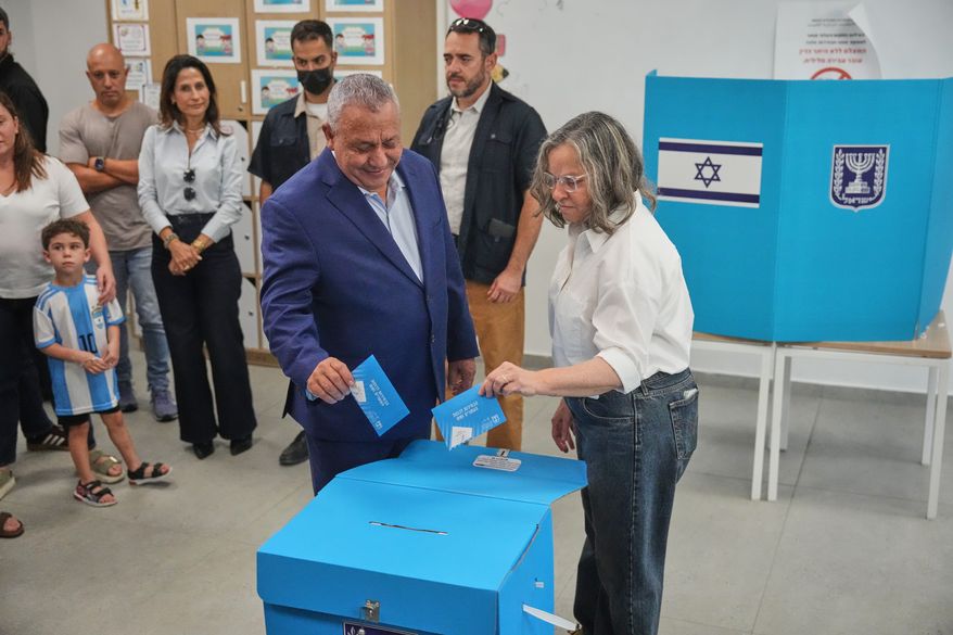 Gadi Eisenkot, leader of the Yashar ("Straight") party, and his wife, Hannah Eisenkot, cast their ballots at a polling station during Israel's general election in Herzliya, Israel, Tuesday, Oct. 27, 2026. (AP Photo/Ariel Schalit)
