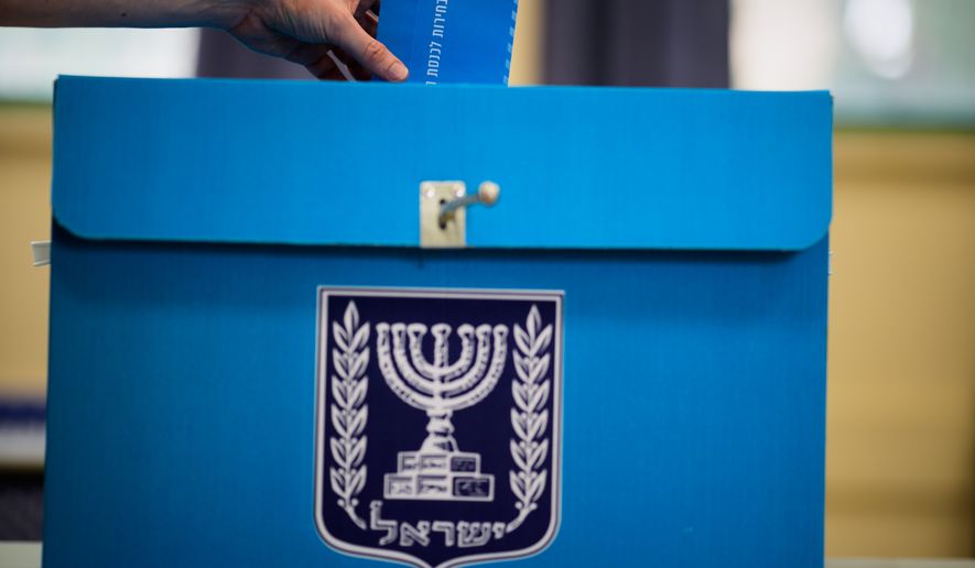A voter casts his ballot at a school used as a polling station during Israel's general election in Tel Aviv, Israel, Tuesday, Oct. 27, 2026. (AP Photo/David Goldman)