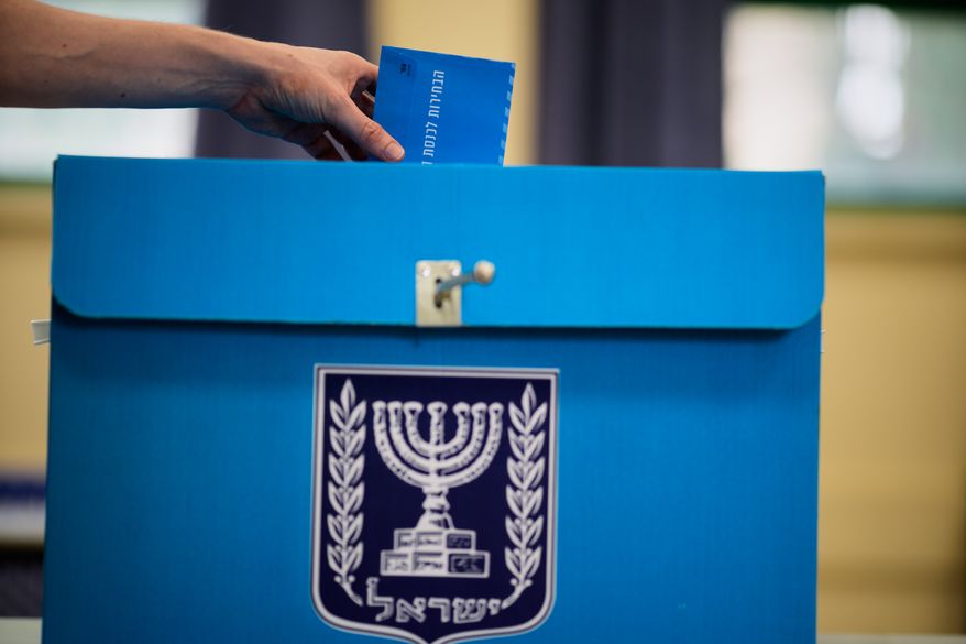 A voter casts his ballot at a school used as a polling station during Israel's general election in Tel Aviv, Israel, Tuesday, Oct. 27, 2026. (AP Photo/David Goldman)