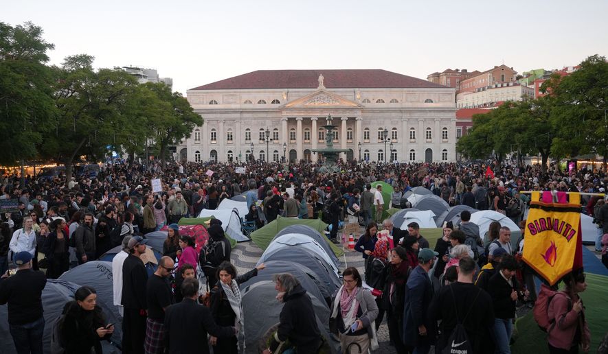 Protestors set up tents to spend the night after a demonstration to demand affordable housing in downtown Lisbon, Saturday, Oct. 24, 2026. (AP Photo/Ana Brigida)