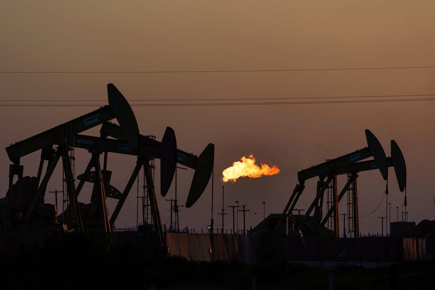 A flare burns off methane and other hydrocarbons as oil pumpjacks operate in the Permian Basin in Midland, Texas, on Oct. 12, 2021. (AP Photo/David Goldman, File)