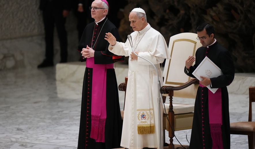 Pope Leo XIV blesses faithful during an audience with participants of the Jesus Youth International Conference in the Paul VI Hall at the Vatican, Saturday, Oct. 24, 2026. (AP Photo/Alessandra Tarantino)