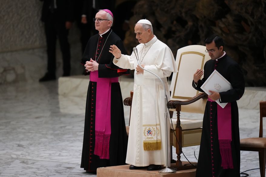 Pope Leo XIV blesses faithful during an audience with participants of the Jesus Youth International Conference in the Paul VI Hall at the Vatican, Saturday, Oct. 24, 2026. (AP Photo/Alessandra Tarantino)