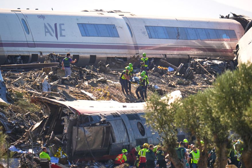 Emergency services attend to the victims at the scene of a collision between two trains in Urda, Spain, on Wednesday, Oct. 28, 2026. (AP Photo/Manu Fernandez)