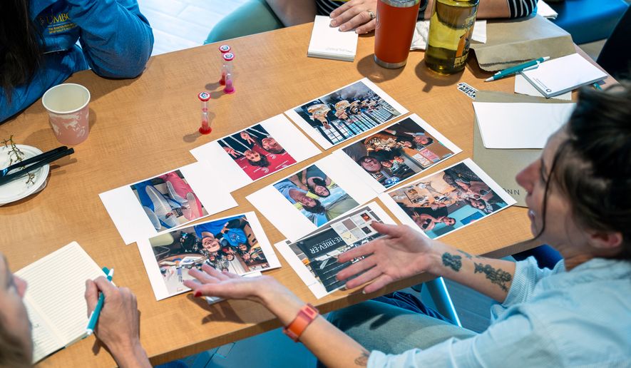 Attendees of the "Picturing Pluralism" retreat share photographs with one another on Oct. 13, 2026, in Baltimore, Md. (Interfaith Photovoice via AP)