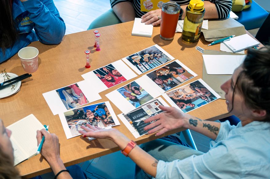 Attendees of the "Picturing Pluralism" retreat share photographs with one another on Oct. 13, 2026, in Baltimore, Md. (Interfaith Photovoice via AP)