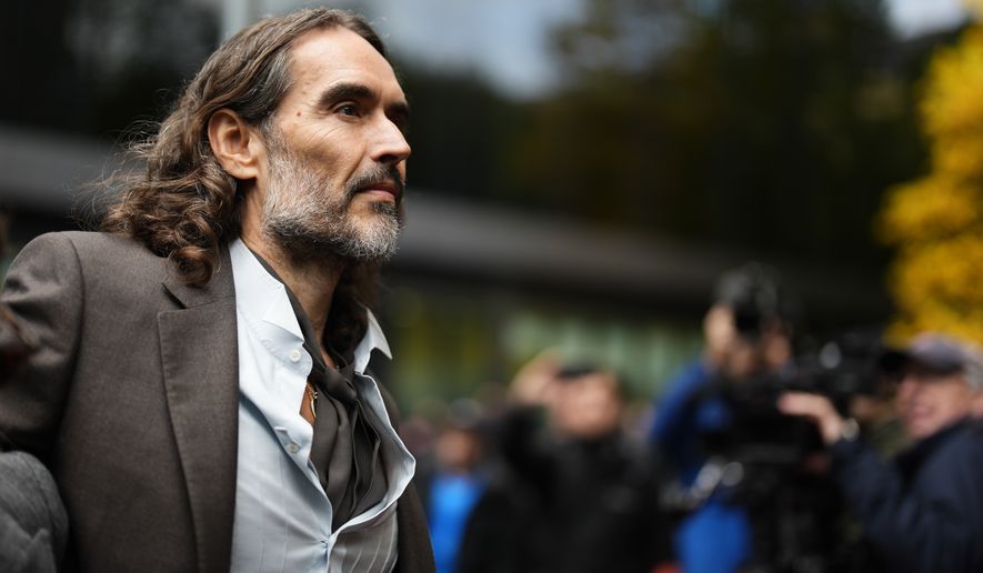 Russell Brand arrives at Southwark Crown Court, London, Tuesday, Oct. 27, 2026, where he faces three charges of rape, indecent assault, and three counts of sexual assault, relating to six women. (Jordan Pettitt/PA via AP)