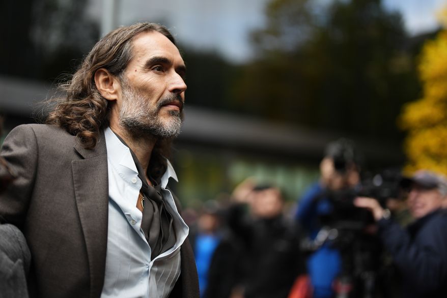 Russell Brand arrives at Southwark Crown Court, London, Tuesday, Oct. 27, 2026, where he faces three charges of rape, indecent assault, and three counts of sexual assault, relating to six women. (Jordan Pettitt/PA via AP)