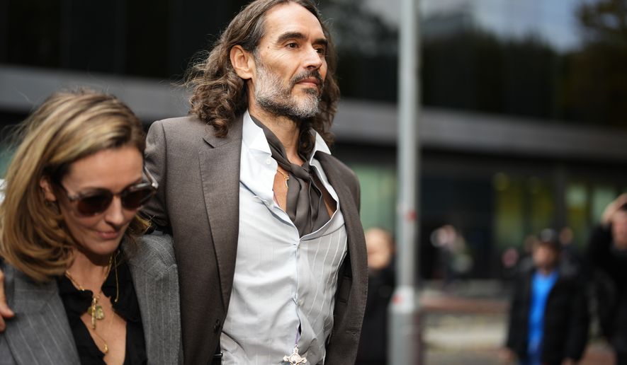 Russell Brand arrives at Southwark Crown Court, London, Tuesday, Oct. 27, 2026, where he faces three charges of rape, indecent assault, and three counts of sexual assault, relating to six women. (Jordan Pettitt/PA via AP)
