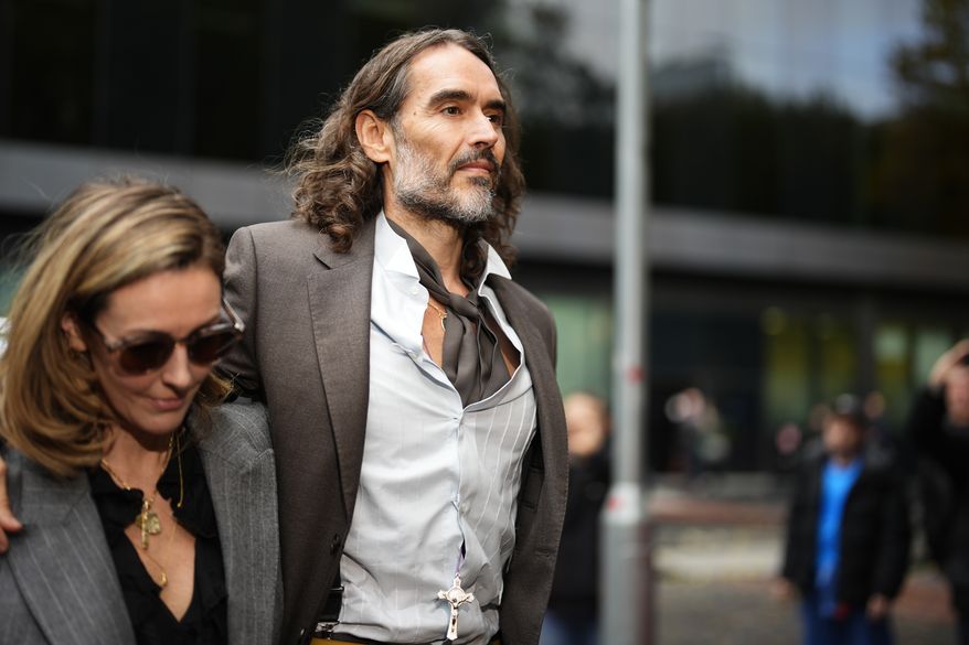 Russell Brand arrives at Southwark Crown Court, London, Tuesday, Oct. 27, 2026, where he faces three charges of rape, indecent assault, and three counts of sexual assault, relating to six women. (Jordan Pettitt/PA via AP)