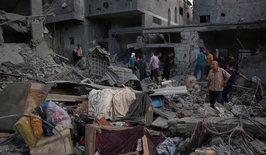Palestinians inspect a building destroyed in an Israeli airstrike late on Thursday in Khan Younis, southern Gaza Strip, Friday, Oct. 9, 2026. (AP Photo/Abdel Kareem Hana)