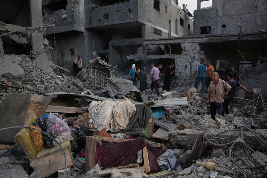 Palestinians inspect a building destroyed in an Israeli airstrike late on Thursday in Khan Younis, southern Gaza Strip, Friday, Oct. 9, 2026. (AP Photo/Abdel Kareem Hana)