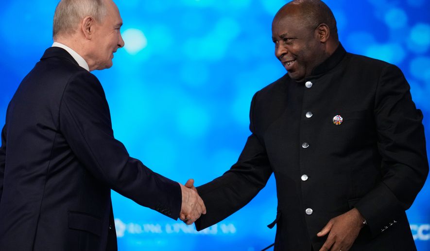 Russian President Vladimir Putin, left, and Burundi's President Evariste Ndayishimiye shake hands during the plenary session of the Russia-Africa Summit in Moscow, Wednesday, Oct. 28, 2026. (AP Photo/Pavel Bednyakov)
