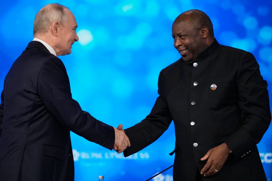 Russian President Vladimir Putin, left, and Burundi's President Evariste Ndayishimiye shake hands during the plenary session of the Russia-Africa Summit in Moscow, Wednesday, Oct. 28, 2026. (AP Photo/Pavel Bednyakov)