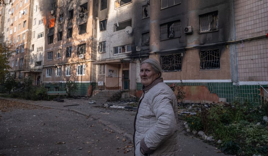 In this photo provided by Ukraine's 93rd Kholodnyi Yar Separate Mechanized Brigade press service and taken Tuesday, Oct. 27, 2026, a local resident leaves her damaged home after a Russian airstrike in Kramatorsk, Donetsk region, Ukraine. (Iryna Rybakova/Ukraine's 93rd Mechanized Brigade via AP)