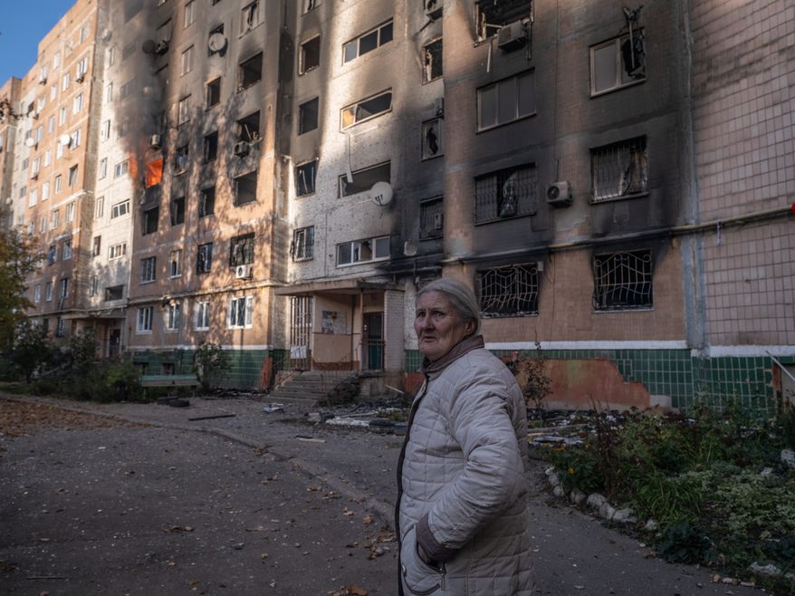 In this photo provided by Ukraine's 93rd Kholodnyi Yar Separate Mechanized Brigade press service and taken Tuesday, Oct. 27, 2026, a local resident leaves her damaged home after a Russian airstrike in Kramatorsk, Donetsk region, Ukraine. (Iryna Rybakova/Ukraine's 93rd Mechanized Brigade via AP)