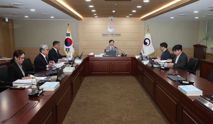 In this photo provided by the Korea Media and Communications Commission (KMCC), KMCC chairperson Kim Jong-cheol, center, speaks during a meeting at the government complex in Gwacheon, South Korea, Wednesday, Oct. 28, 2026. (The Korea Media and Communications Commission via AP)