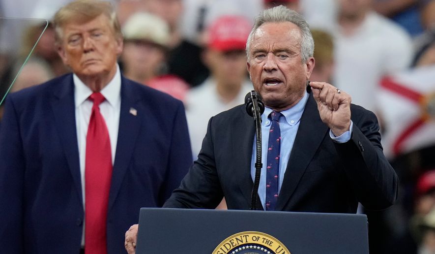 Health and Human Services Secretary Robert F. Kennedy Jr. speaks as President Donald Trump listens during a campaign rally, Friday, Oct. 23, 2026, at Alico Arena on the campus of Florida Gulf Coast University in Fort Myers, Fla. (AP Photo/Chris O'Meara)