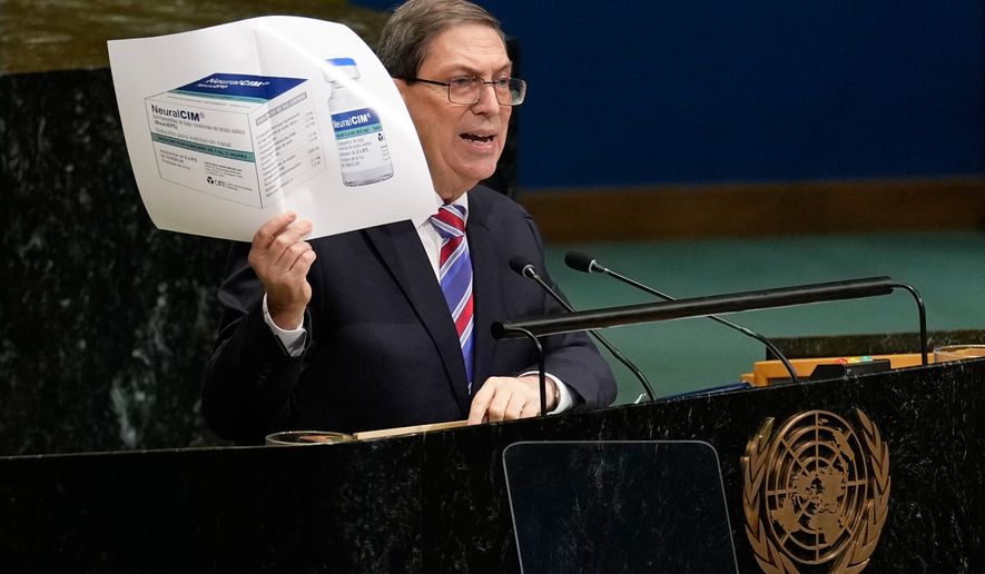Cuban foreign minister Bruno Rodriguez Parrilla holds up a photo of a medication while speaking at United Nations headquarters, Wednesday, Oct. 28, 2026. (AP Photo/Seth Wenig)