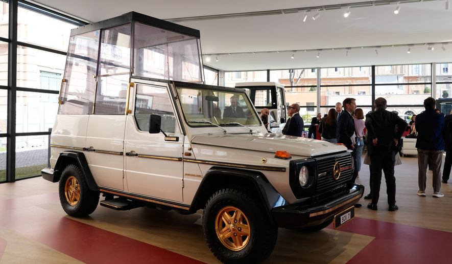 A popemobile used by successive popes is displayed at "A Century of the Popemobile," an exhibition tracing 100 years of papal transportation, from Pope Pius XI's first automobile in 1930 to modern popemobiles, at the Vatican Museums, Wednesday, Oct. 28, 2026. (AP Photo/Isaia Montelione)