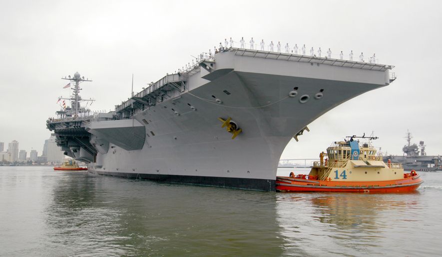 Ending her 10-plus-year service as the Navy's only forward-deployed aircraft carrier, USS Kitty Hawk, far right, remains moored to the pier as tugboats assist the aircraft carrier USS George Washington depart Naval Air Station North Island. George Washington will replace Kitty Hawk as the Navy's only permanently forward-deployed carrier operating from Yokosuka, Japan. Photo courtesy of U.S. Navy.