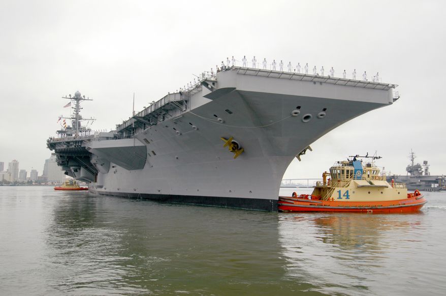 Ending her 10-plus-year service as the Navy's only forward-deployed aircraft carrier, USS Kitty Hawk, far right, remains moored to the pier as tugboats assist the aircraft carrier USS George Washington depart Naval Air Station North Island. George Washington will replace Kitty Hawk as the Navy's only permanently forward-deployed carrier operating from Yokosuka, Japan. Photo courtesy of U.S. Navy.