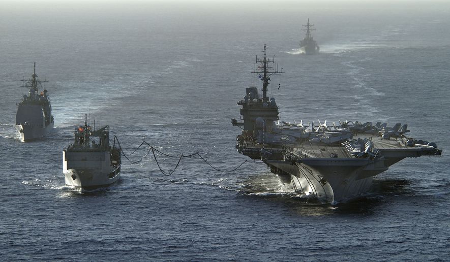 The aircraft carrier USS Kitty Hawk (CV 63) receives fuel during a replenishment at sea from the Royal Australian Navy auxiliary oiler replenishment vessel HMAS Success (AOR 304) on June 14, 2005. DoD photo by Petty Officer 2nd Class William H. Ramsey, U.S. Navy. (Released).