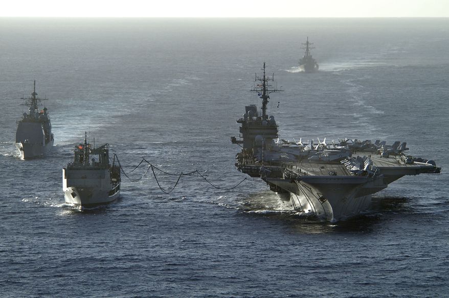 The aircraft carrier USS Kitty Hawk (CV 63) receives fuel during a replenishment at sea from the Royal Australian Navy auxiliary oiler replenishment vessel HMAS Success (AOR 304) on June 14, 2005. DoD photo by Petty Officer 2nd Class William H. Ramsey, U.S. Navy. (Released).