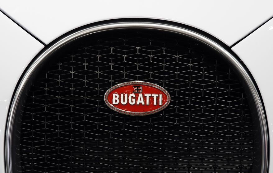 The front grille emblem of a Bugatti Chiron is pictured at the Auto show in Paris, France, Wednesday, Oct. 3, 2018, 2018. All-electric vehicles with zero local emissions are among the stars of the Paris auto show, rubbing shoulders with the fossil-fuel burning SUVs that many car buyers love. (AP Photo/Christophe Ena)