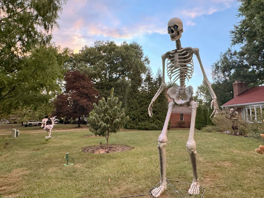 A 12-foot Home Depot skeleton stands in the front yard of a Cincinnati home on Sept. 24, 2024. (AP Photo/Sallee Ann Harrison, File)