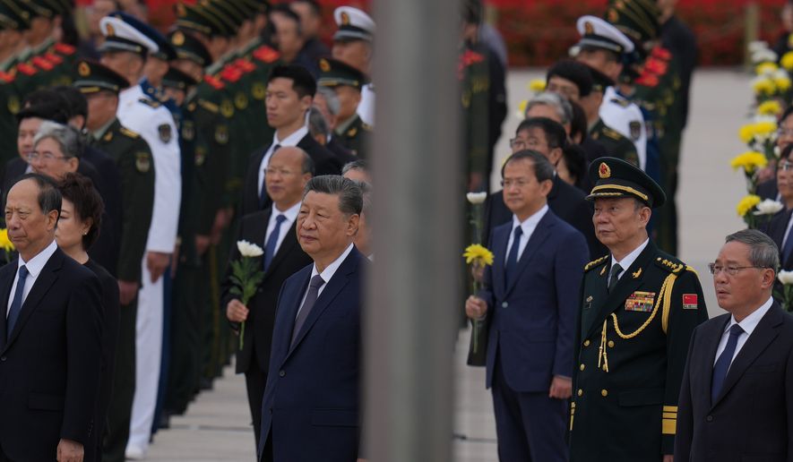 Chinese President Xi Jinping, center left and Zhang Shengmin, Vice Chairman of the Central Military Commission second from right attend a ceremony in honor of fallen national heroes at the Monument to the People's Heroes to mark Martyrs' Day at Tiananmen Square in Beijing, Wednesday, Sept. 30, 2026. (AP Photo/Ng Han Guan)