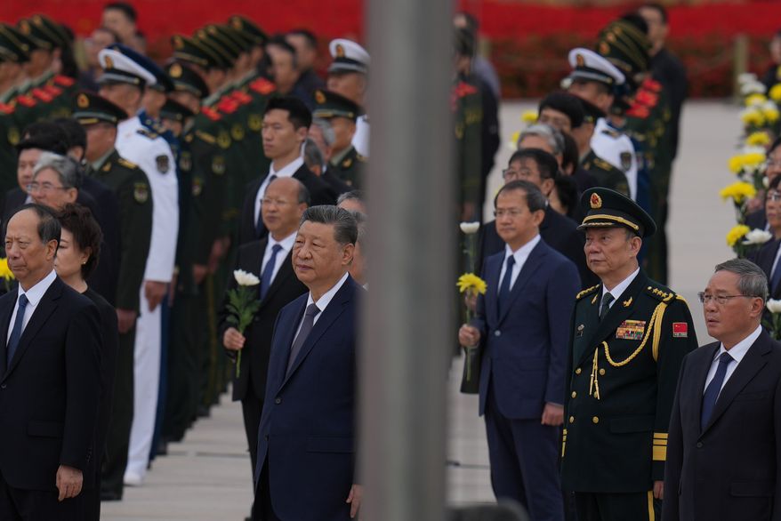 Chinese President Xi Jinping, center left and Zhang Shengmin, Vice Chairman of the Central Military Commission second from right attend a ceremony in honor of fallen national heroes at the Monument to the People's Heroes to mark Martyrs' Day at Tiananmen Square in Beijing, Wednesday, Sept. 30, 2026. (AP Photo/Ng Han Guan)