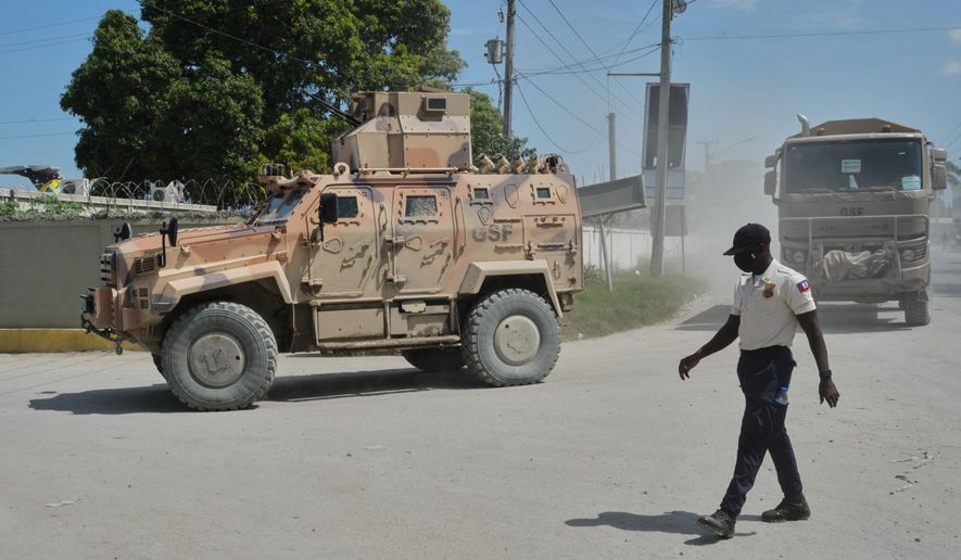 Armored police vehicles that are part of the Gang Suppression Force (GSF) patrol near the airport in Port-au-Prince, Haiti, Tuesday, Oct. 20, 2026. (AP Photo/Odelyn Joseph)