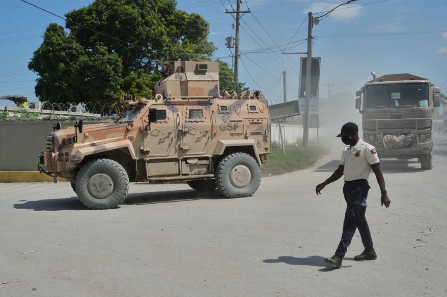 Armored police vehicles that are part of the Gang Suppression Force (GSF) patrol near the airport in Port-au-Prince, Haiti, Tuesday, Oct. 20, 2026. (AP Photo/Odelyn Joseph)