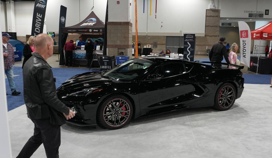 A person looks over a 2026 Chevrolet Corvette Stingray 3LT on display at the Colorado Auto Show Friday, April 10, 2026, in Denver. (AP Photo/David Zalubowski)