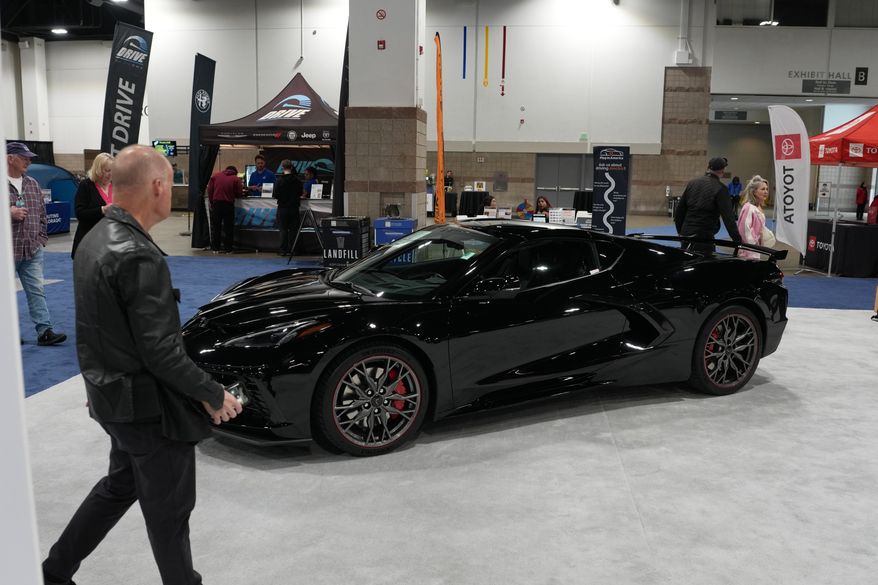A person looks over a 2026 Chevrolet Corvette Stingray 3LT on display at the Colorado Auto Show Friday, April 10, 2026, in Denver. (AP Photo/David Zalubowski)
