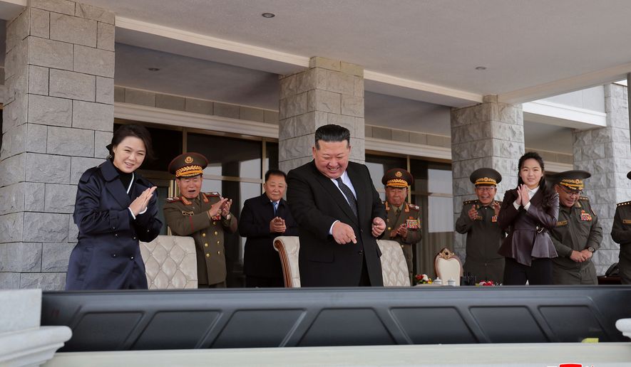 In this photo provided on Oct. 30, 2026, by the North Korean government, its leader Kim Jong Un, center, his wife Ri Sol Ju, left, and their daughter, front right, watch the monitors showing the demonstrations held at an exhibition of a variety of attack and other drones at the Wonsan-Kalma coastal tourist area, North Korea, Thursday, Oct. 29, 2026. Independent journalists were not given access to cover the event depicted in this image distributed by the North Korean government. The content of this image is as provided and cannot be independently verified. Korean language watermark on image as provided by source reads: "KCNA" which is the abbreviation for Korean Central News Agency. (Korean Central News Agency/Korea News Service via AP)