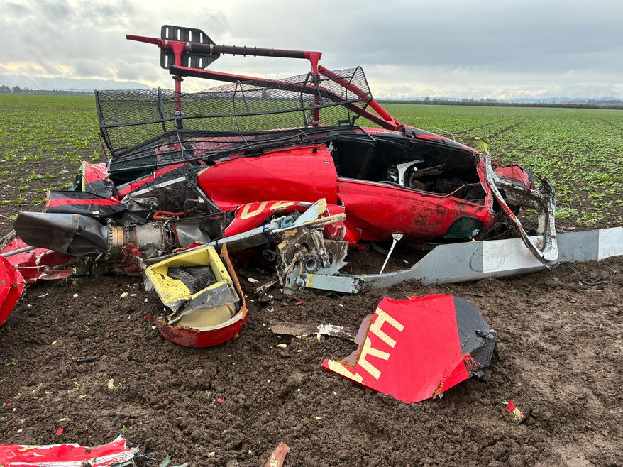 This photo released by the Yamhill County Sheriff's Office shows a damaged helicopter after two helicopters collided and crashed into a farm field in Yamhill County, Ore., Thursday, Oct. 29, 2026. (Yamhill County Sheriff's Office via AP)