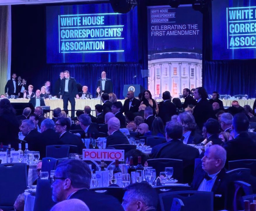 FILE - U.S. Secret Service agents respond near President Donald Trump and first lady Melania Trump during the White House Correspondents Dinner, April 25, 2026, in Washington. (AP Photo/Alex Brandon, File)