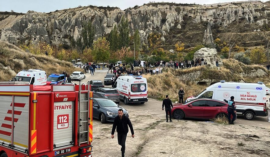 Emergency teams work in the aftermath where parts of a volcanic rock formation collapsed in Cappadocia, central Turkey, Thursday, Oct. 29, 2026. (Turan Bulut/IHA via AP)