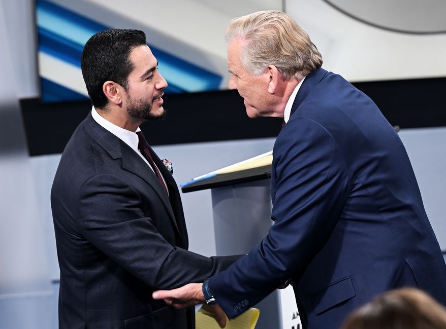 U.S. Senate candidates Democrat Abdul El-Sayed, left, and Republican Mike Rogers shake hands after the debate on Wednesday, Oct. 21, 2026 at WXYZ Channel 7 in Southfield, Mich. (Robin Buckson/Detroit News via AP, Pool)